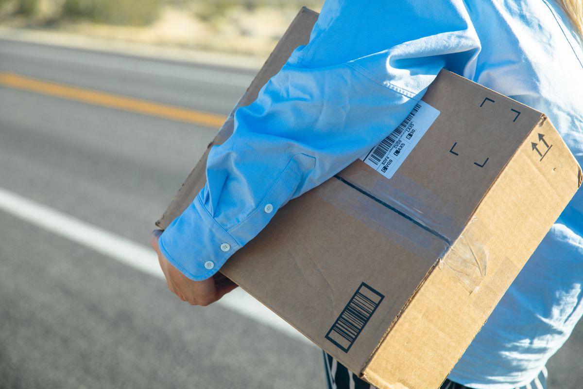 Person carrying a package for shipping